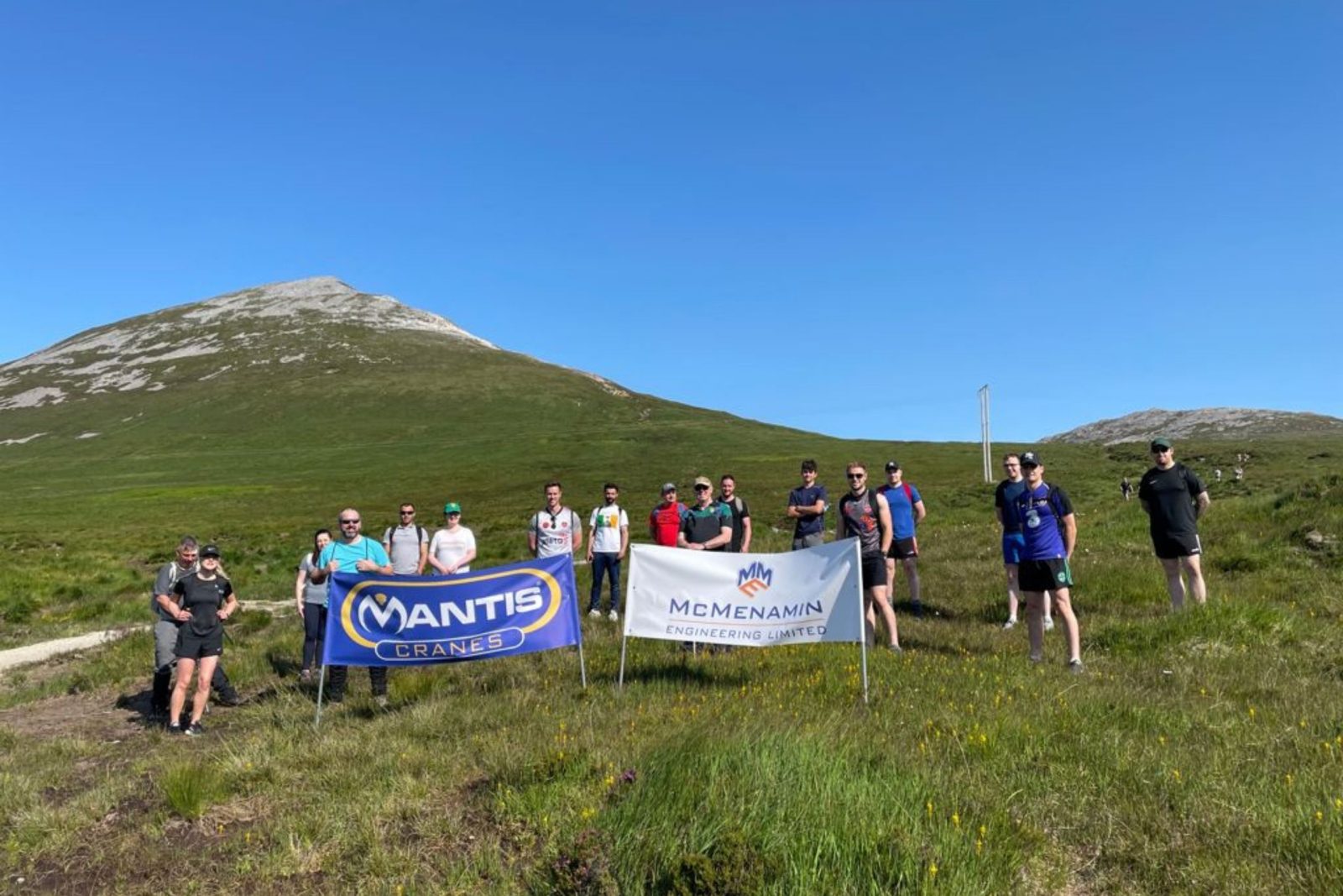 A photo of mantis cranes and amcmenamin engineering staff who climber mount errigal for charity